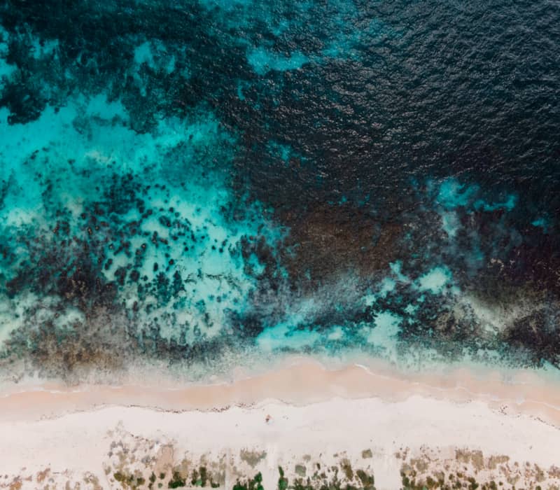 Birds eye view of a sandy beach with reef on the West Coast.