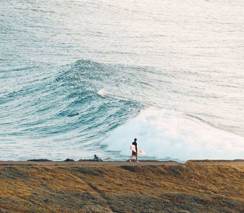 Surfer walking with a surfboard at Crescent Head Mid North Coast NSW