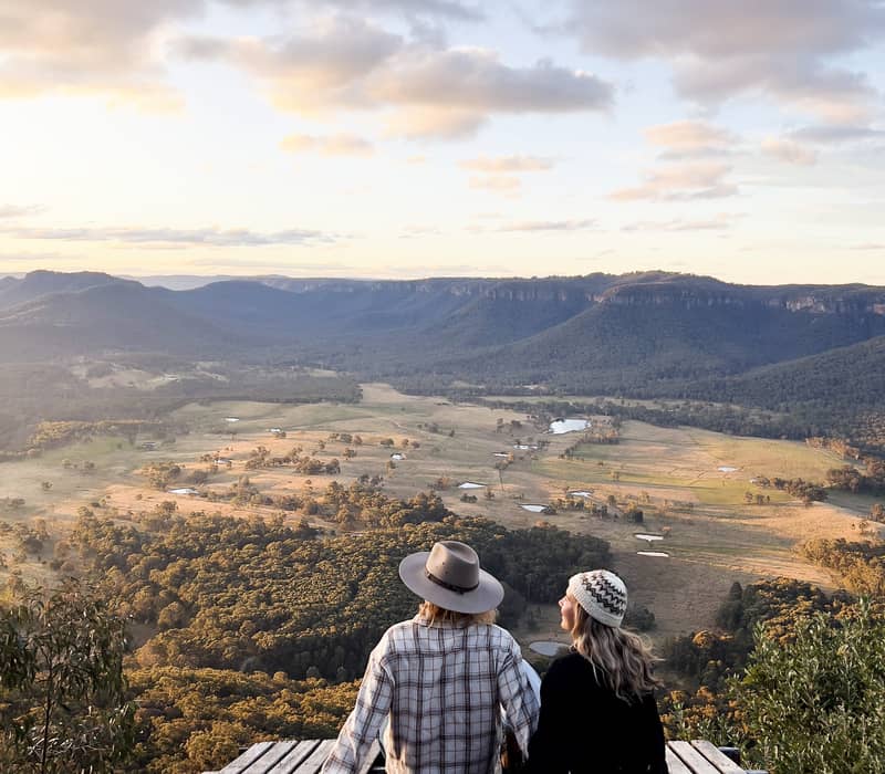 Couple sitting admiring view near Mount Blackhealth NSW